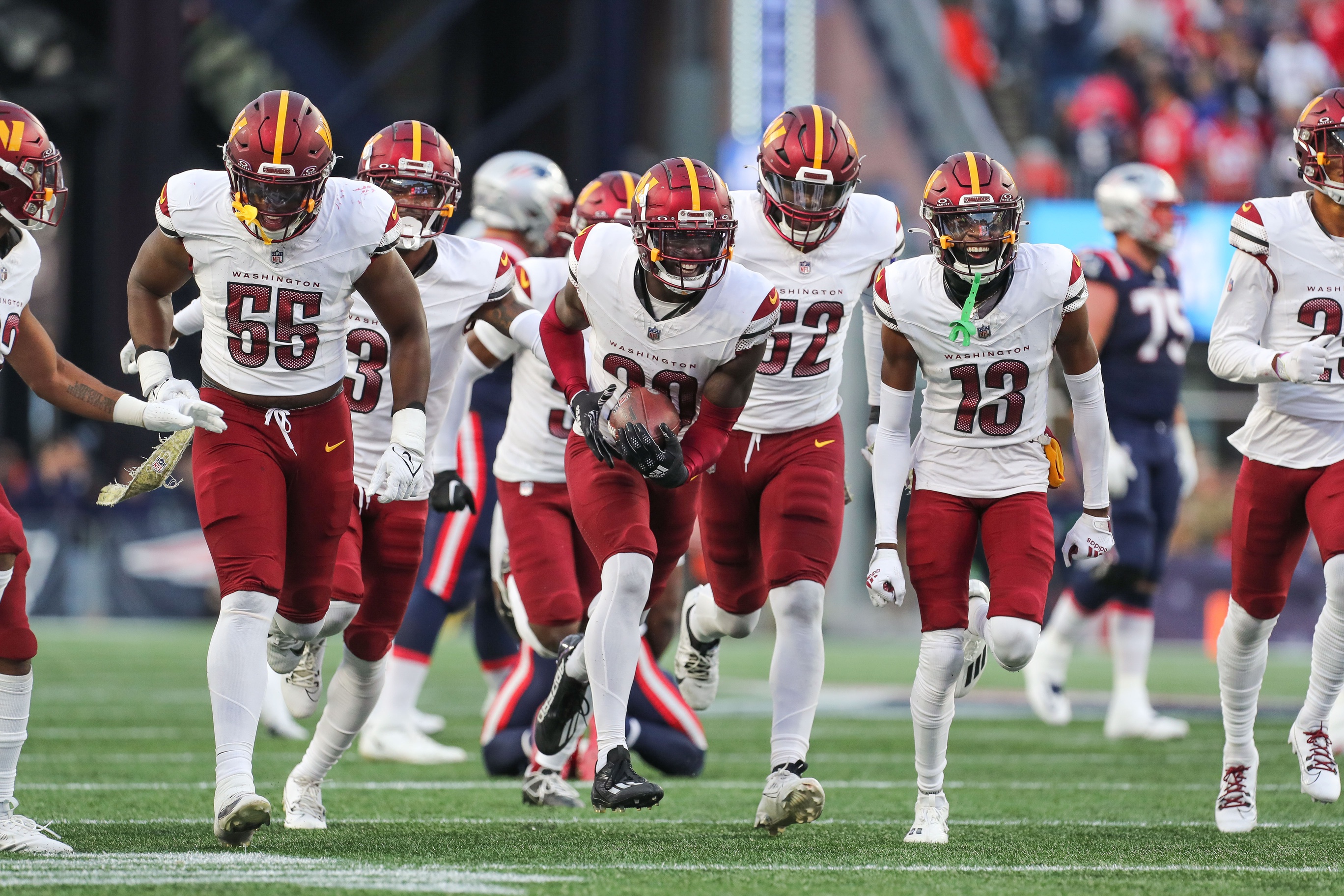 Nov 5, 2023; Foxborough, Massachusetts, USA; Washington Commanders cornerback Jartavius Martin (20) celebrates after an interception during the second half against the New England Patriots at Gillette Stadium.
